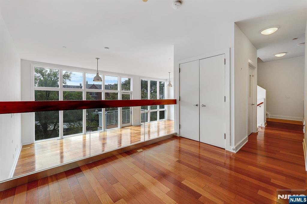 22 Vela Way Edgewater, NJ 07020 - Photo 7 of 43 a view of a porch with wooden floor and windows