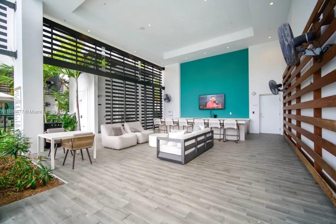 1919 Southeast 10th Avenue, Unit 2121 Fort Lauderdale, FL 33316 - Photo 11 of 35 a living room with furniture and a flat screen tv