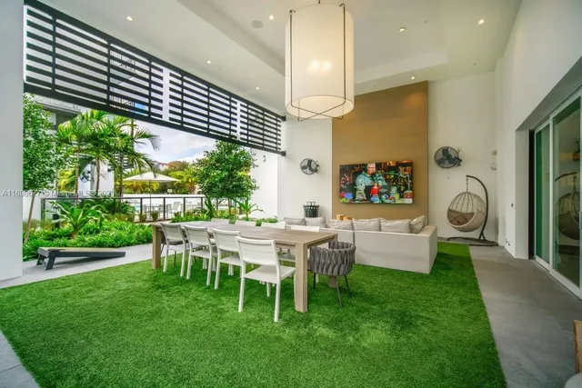 a view of a patio with table and chairs under an umbrella
