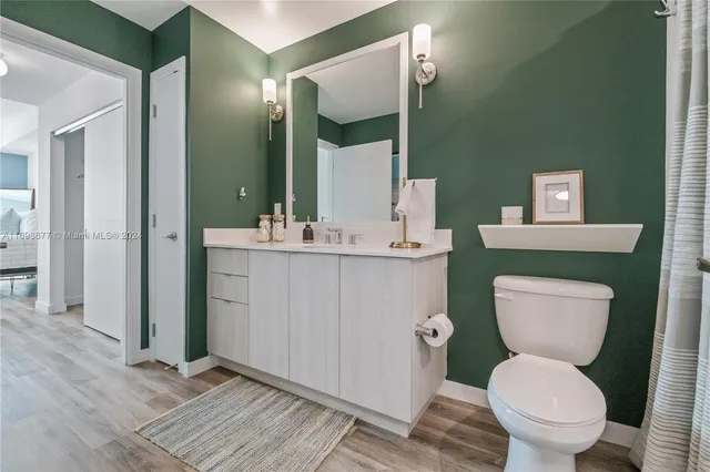 a bathroom with a double vanity sink toilet and shower