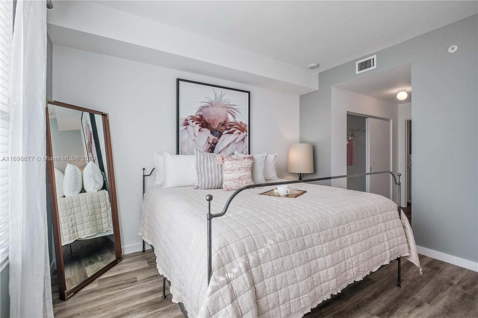 1919 Southeast 10th Avenue, Unit 2121 Fort Lauderdale, FL 33316 - Photo 31 of 35 a bedroom with a white bed and a painting on the wall