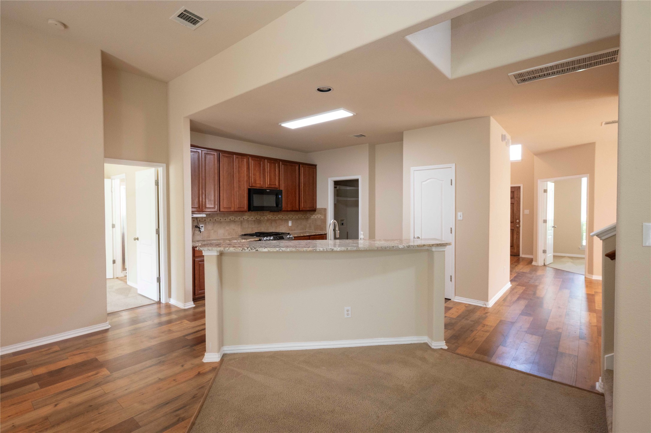 2070 Intrepid Drive Buda, TX 78610 - Photo 4 of 31 An inviting open-concept kitchen with granite counters flows seamlessly into living spaces, perfect for gatherings.