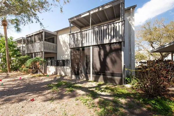 a view of a house with a small yard and wooden fence