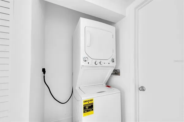 a living room with a floor to ceiling window and wooden floor