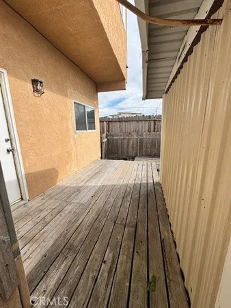 a view of balcony with wooden floor and staircase