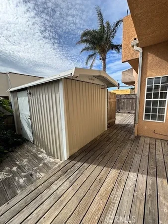 a view of backyard with wooden roof and potted plants
