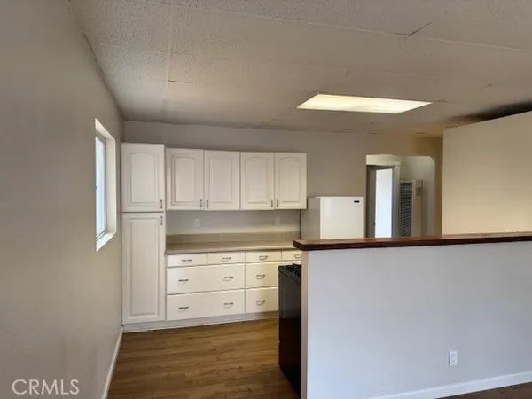 a kitchen with stainless steel appliances granite countertop a refrigerator and a stove