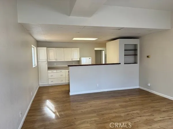 a view of a kitchen with a sink and cabinets