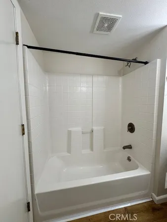 a bathroom with a bathtub and a shower
