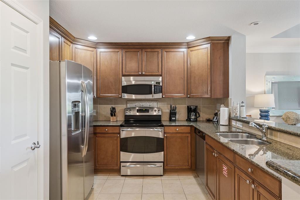 1100 Sunset View Circle, Unit 102 Reunion, FL 34747 - Photo 11 of 67 a kitchen with a sink stainless steel appliances and cabinets