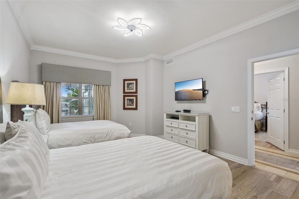 1100 Sunset View Circle, Unit 102 Reunion, FL 34747 - Photo 18 of 67 a bedroom with a bed and a flat screen tv