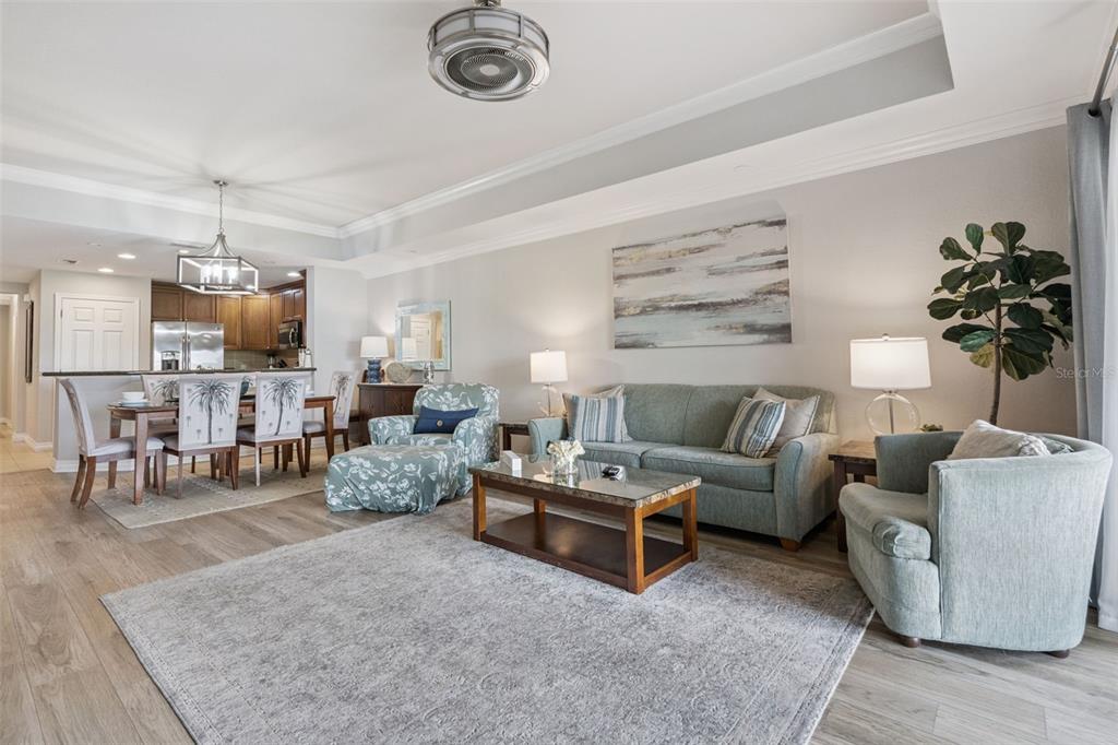 1100 Sunset View Circle, Unit 102 Reunion, FL 34747 - Photo 19 of 67 a living room with furniture kitchen view and a chandelier