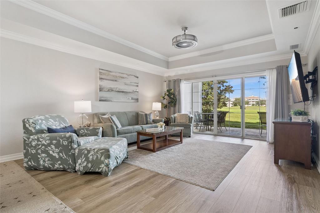 1100 Sunset View Circle, Unit 102 Reunion, FL 34747 - Photo 22 of 67 a living room with furniture and a flat screen tv