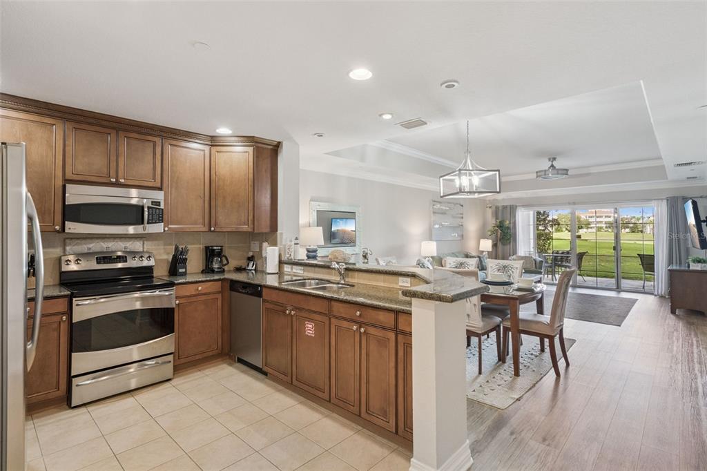 1100 Sunset View Circle, Unit 102 Reunion, FL 34747 - Photo 23 of 67 a kitchen with lots of counter top space and appliances