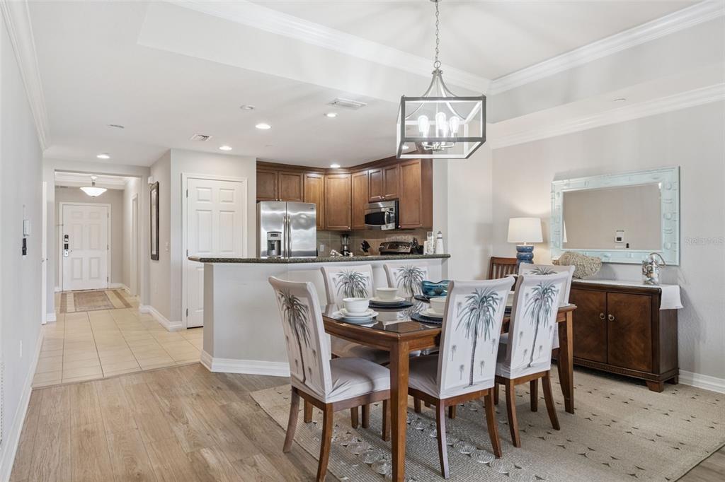 1100 Sunset View Circle, Unit 102 Reunion, FL 34747 - Photo 25 of 67 a view of a dining room and livingroom with furniture wooden floor a chandelier