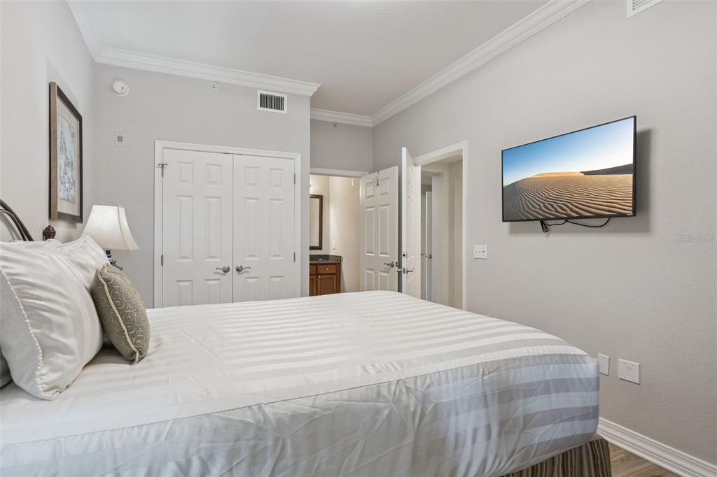 1100 Sunset View Circle, Unit 102 Reunion, FL 34747 - Photo 26 of 67 a bedroom with a bed and a flat screen tv
