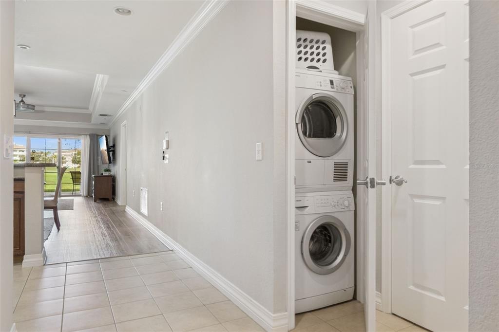1100 Sunset View Circle, Unit 102 Reunion, FL 34747 - Photo 30 of 67 a view of a hallway with washer and dryer