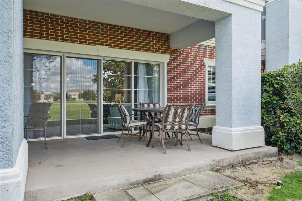 1100 Sunset View Circle, Unit 102 Reunion, FL 34747 - Photo 33 of 67 a view of a patio with table and chairs and potted plants