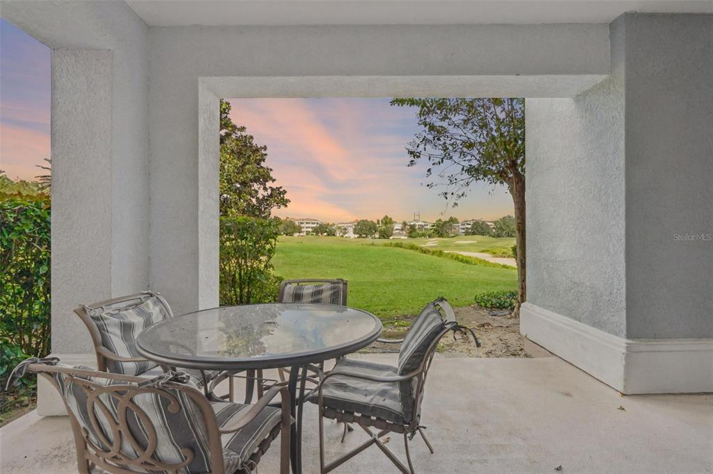 1100 Sunset View Circle, Unit 102 Reunion, FL 34747 - Photo 37 of 67 a view of an outdoor dining space with a table and chairs