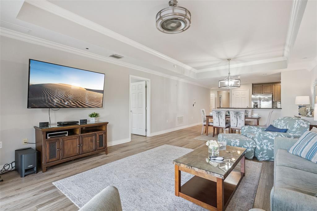 1100 Sunset View Circle, Unit 102 Reunion, FL 34747 - Photo 4 of 67 a living room with furniture and a flat screen tv