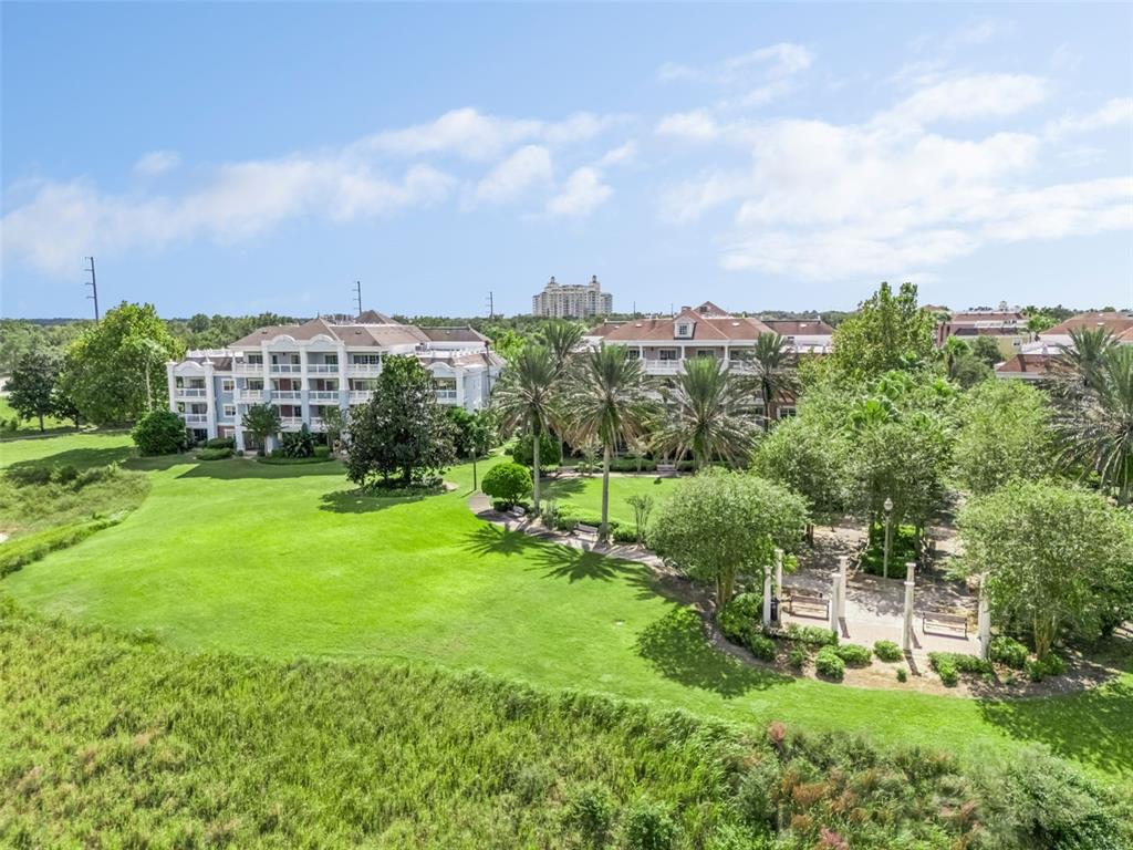 1100 Sunset View Circle, Unit 102 Reunion, FL 34747 - Photo 43 of 67 a view of a garden with a building in the back