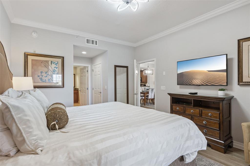 1100 Sunset View Circle, Unit 102 Reunion, FL 34747 - Photo 8 of 67 a bedroom with a bed and a flat screen tv