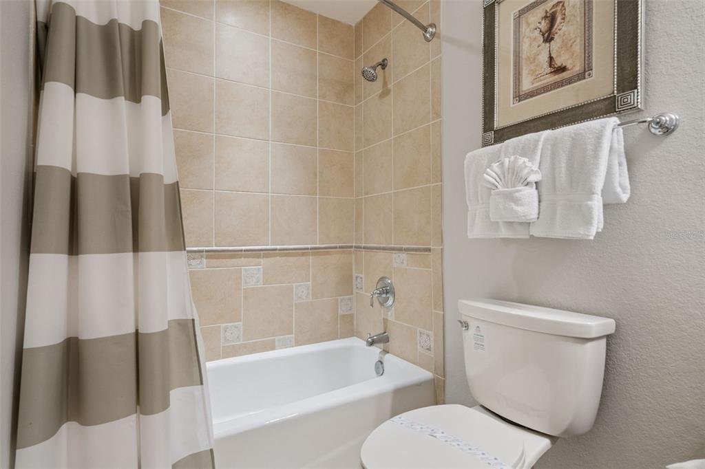 1100 Sunset View Circle, Unit 102 Reunion, FL 34747 - Photo 9 of 67 a white toilet sitting next to a bath tub
