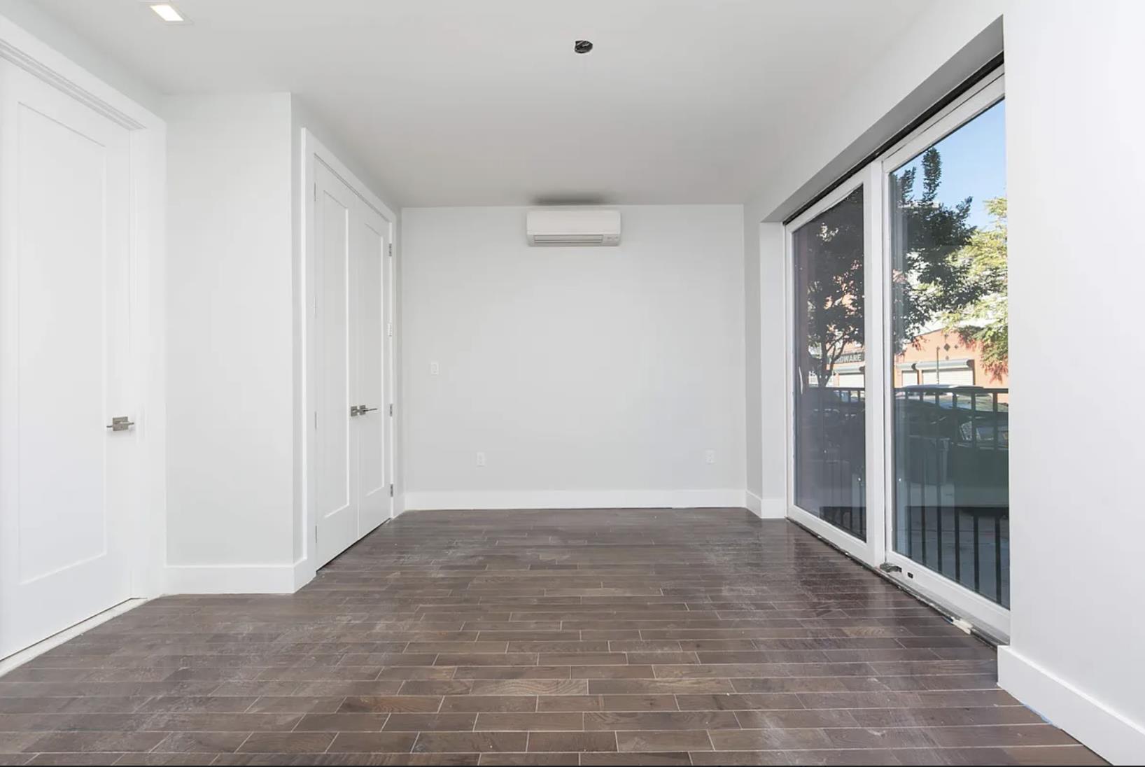 188 Butler Street Brooklyn, NY 11217 - Photo 4 of 12 a view of an empty room with wooden floor and a window