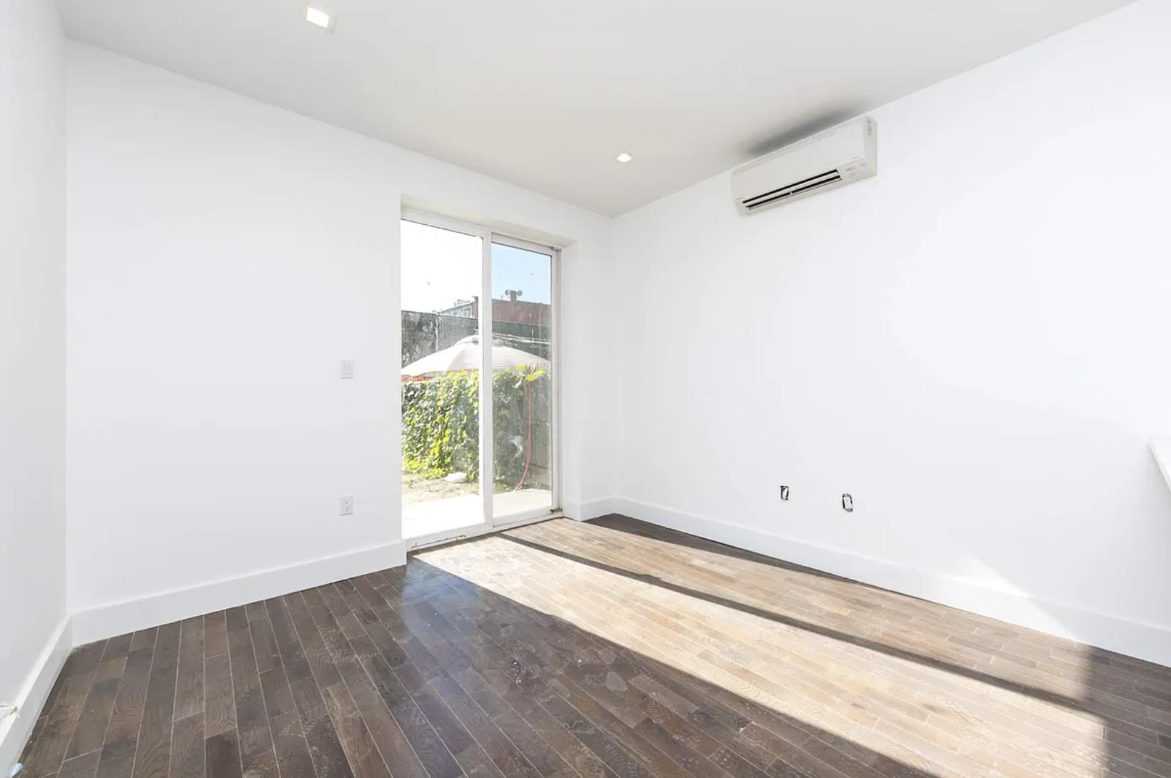 188 Butler Street Brooklyn, NY 11217 - Photo 7 of 12 an empty room with wooden floor and windows