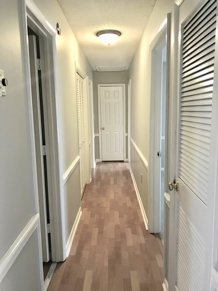 102 Valley Ridge Drive Perry, GA 31069 - Photo 16 of 25 a view of a hallway with wooden floor and closet area