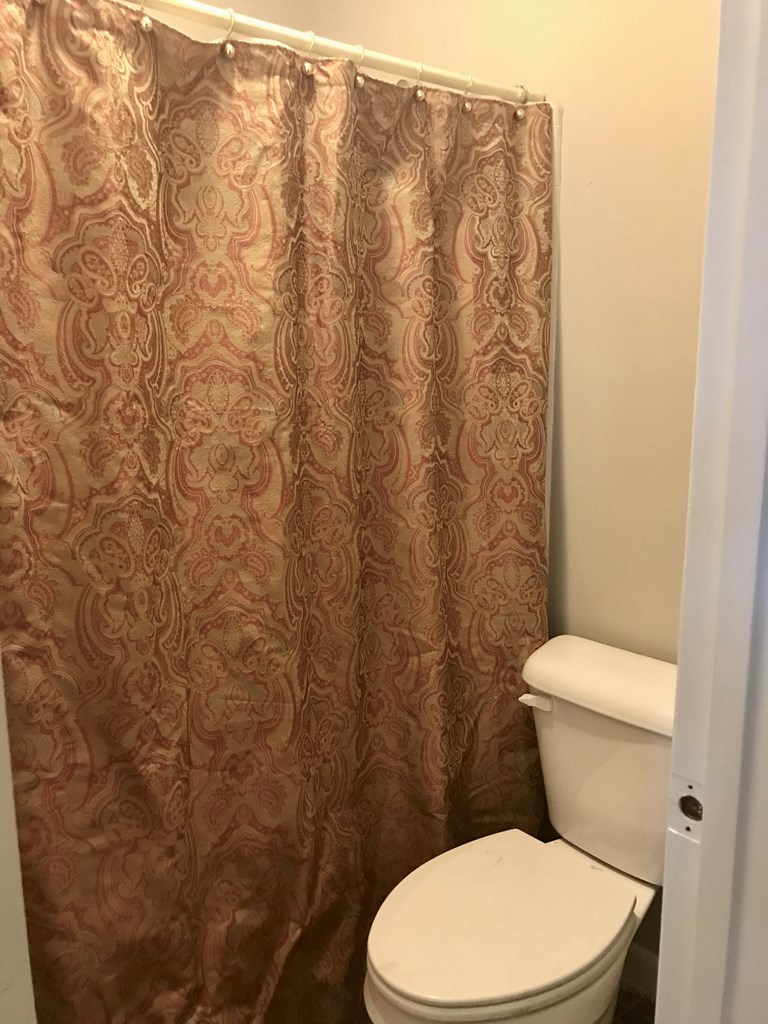 102 Valley Ridge Drive Perry, GA 31069 - Photo 20 of 25 a white toilet sitting next to a white wall