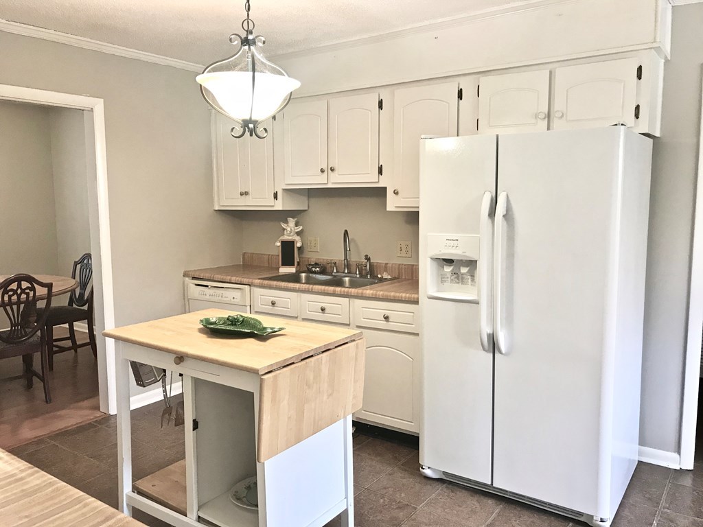 102 Valley Ridge Drive Perry, GA 31069 - Photo 6 of 25 a kitchen with stainless steel appliances granite countertop a sink a refrigerator a stove a dining table and chairs