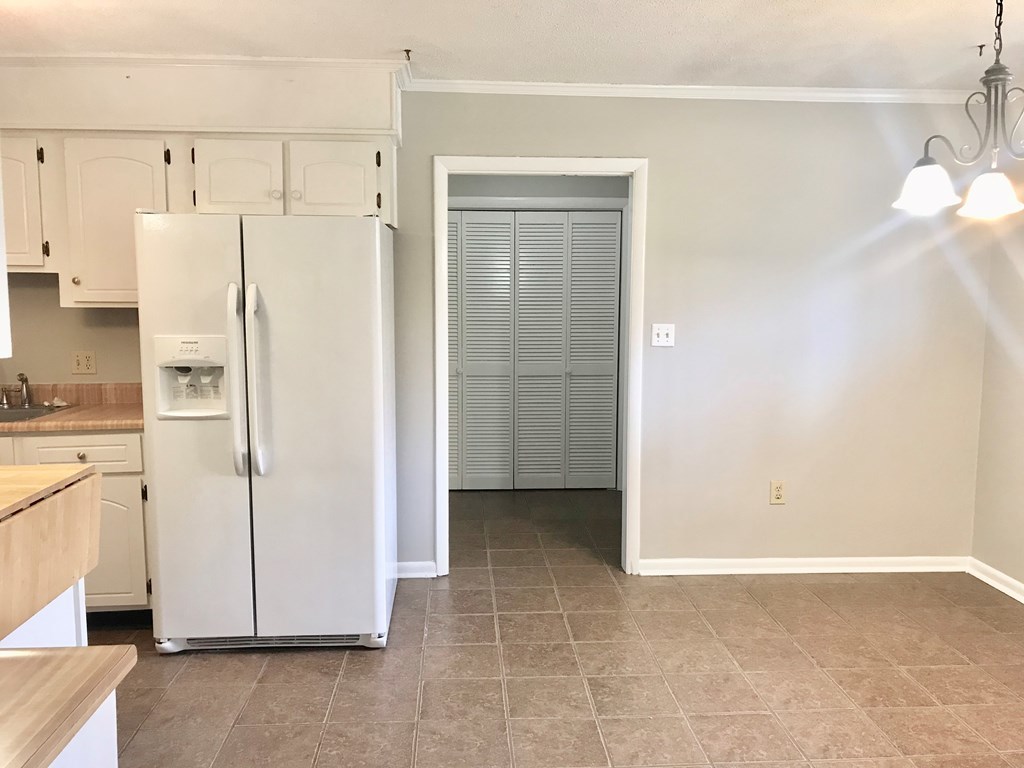 102 Valley Ridge Drive Perry, GA 31069 - Photo 7 of 25 a view of a kitchen with white cabinets and refrigerator