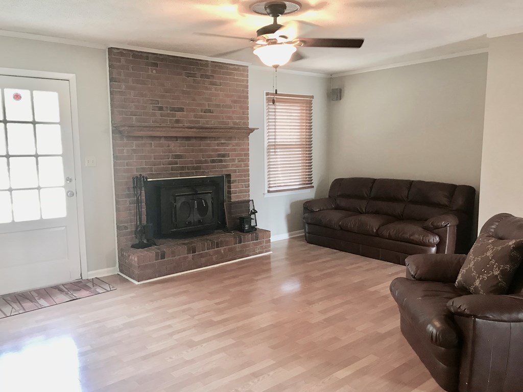 102 Valley Ridge Drive Perry, GA 31069 - Photo 10 of 25 a living room with furniture a flat screen tv and a fireplace