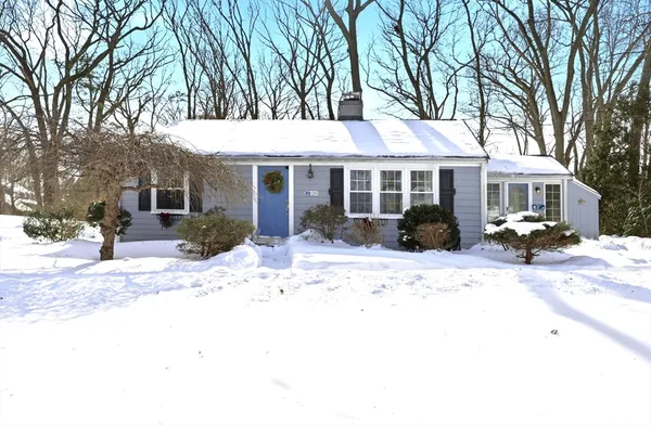 a front view of a house with a yard and glass windows