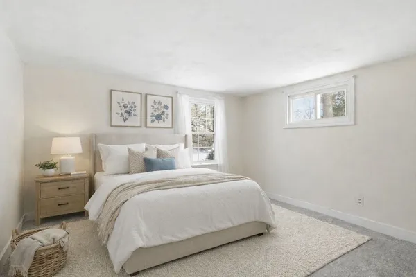 a bedroom with a bed and a painting on the wall