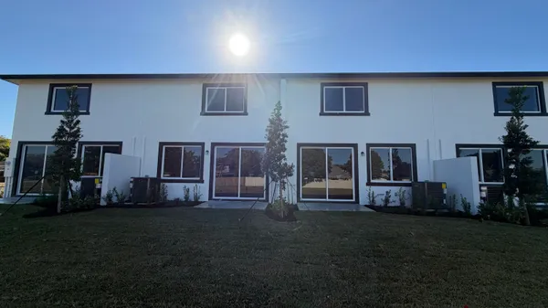 a living room with lots of furniture and gym equipment