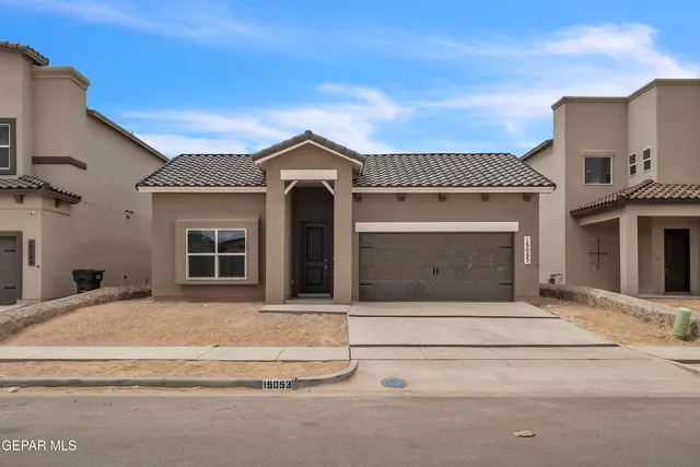 a front view of a house with a garage