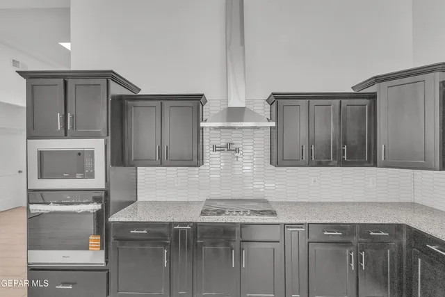 a kitchen with granite countertop a sink and a stove