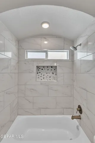 a bathroom with a bathtub and shower