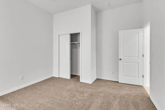 a view of an empty room and closet area