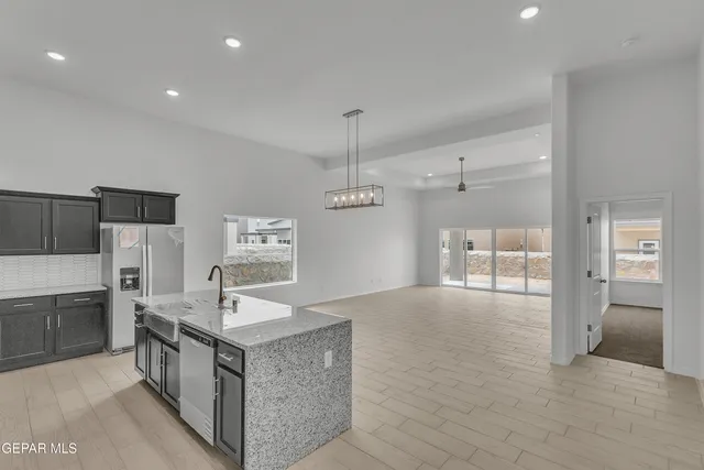 a large kitchen with stainless steel appliances granite countertop a large counter top and a stove