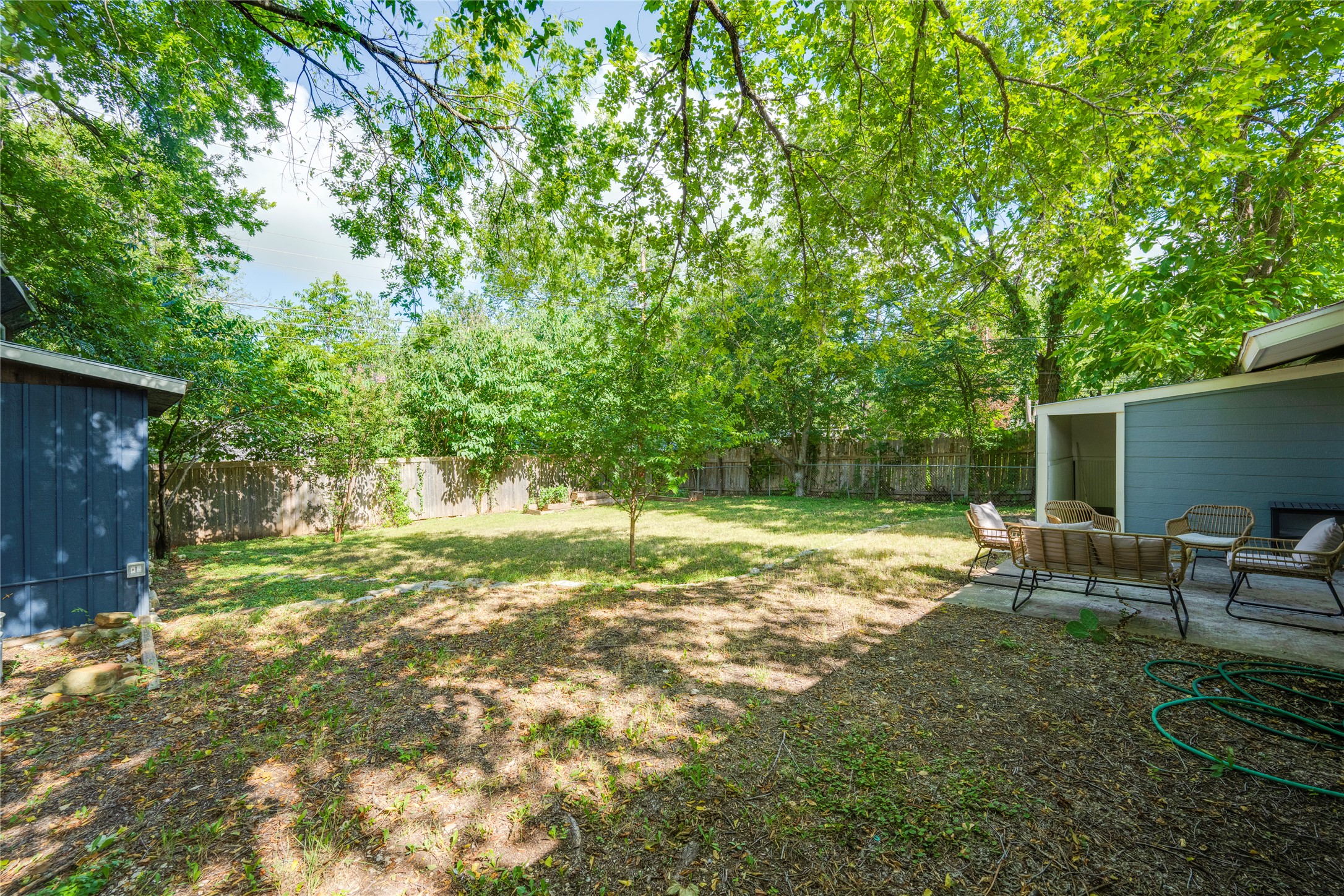 5300 Halmark Drive Austin, TX 78723 - Photo 38 of 40 A spacious, naturally shaded backyard features a charming patio perfect for outdoor living.