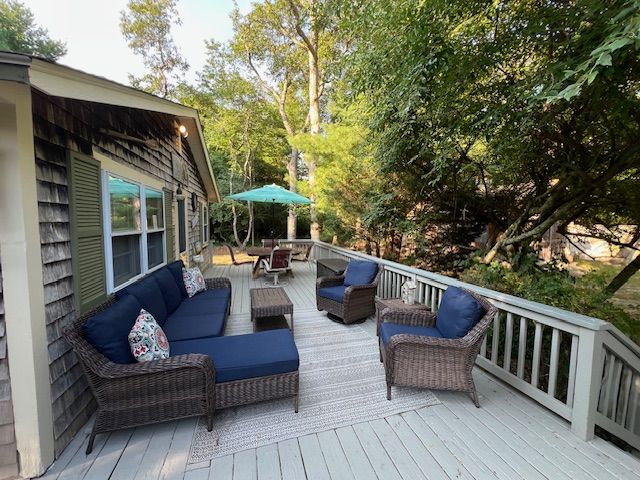 60 R Carol Lane Oak Bluffs, MA 02557 - Photo 12 of 14 a outdoor space with patio the couches and a dining table with chairs