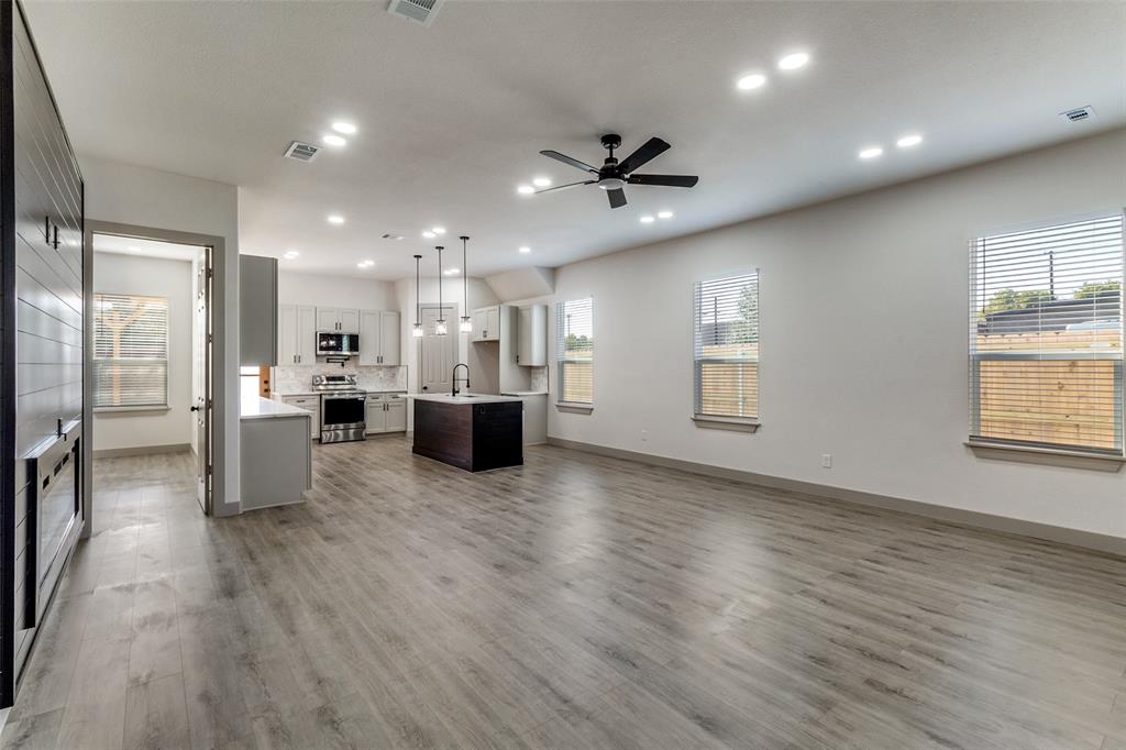 917 South Carroll Avenue Dallas, TX 75223 - Photo 4 of 30 Unfurnished living room featuring plenty of natural light, light wood finished floors, ceiling fan, and recessed lighting