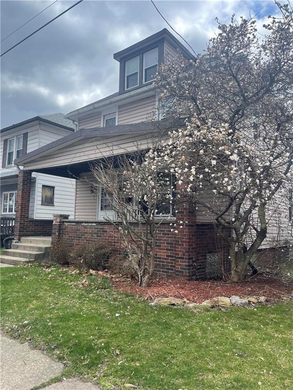 462 Mecklem Avenue Rochester, PA 15074 - Photo 2 of 18 a front view of a house with a garden and yard