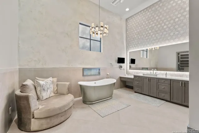 a living room with furniture a chandelier and a couch