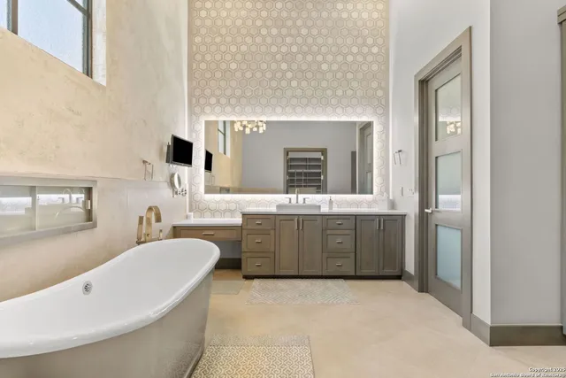 a bathroom with a tub sink and mirror