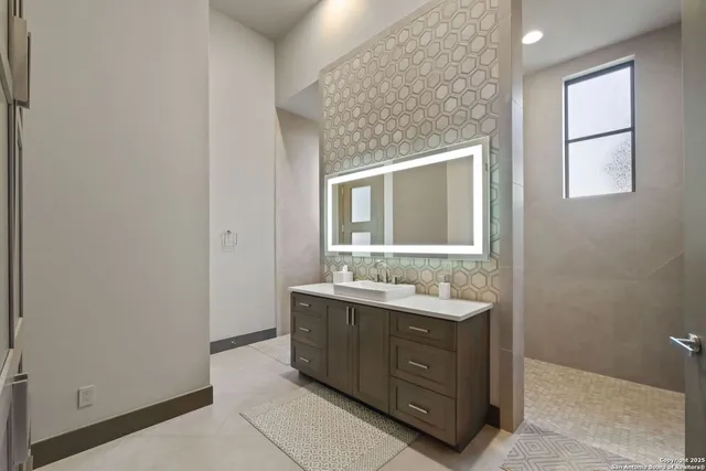 a bathroom with a double vanity sink and mirror