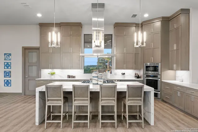 a large kitchen with a table and chairs